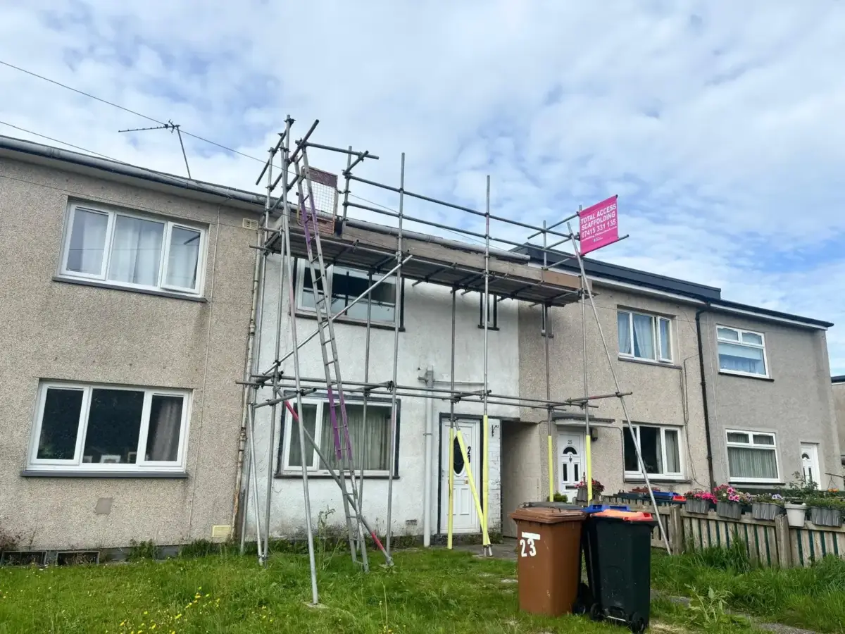 Scaffold access platform on residential building for roof maintenance