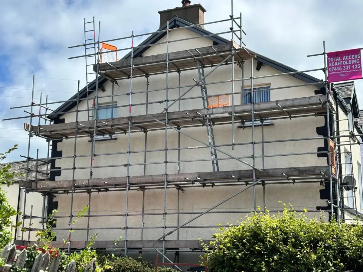 Free-standing scaffold tower on end-terrace property for gable work in Cumbria