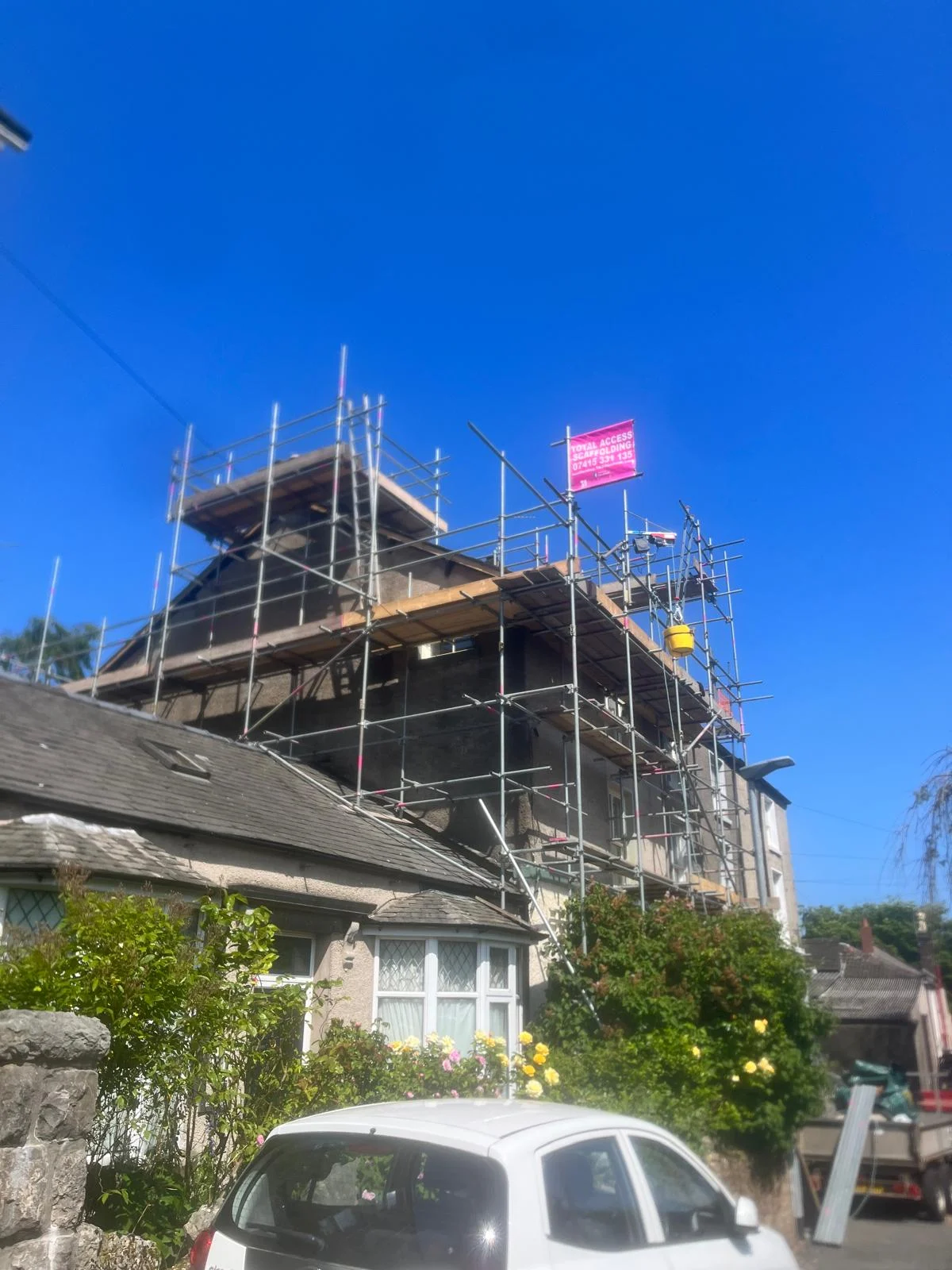 Close-up of chimney scaffold with guardrails for safe access during repairs