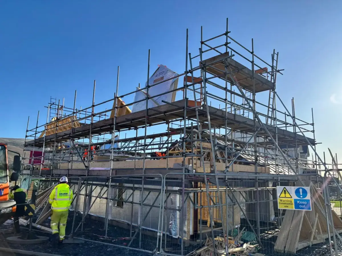 Scaffolding around completed new build house for external finishing at Bootle
