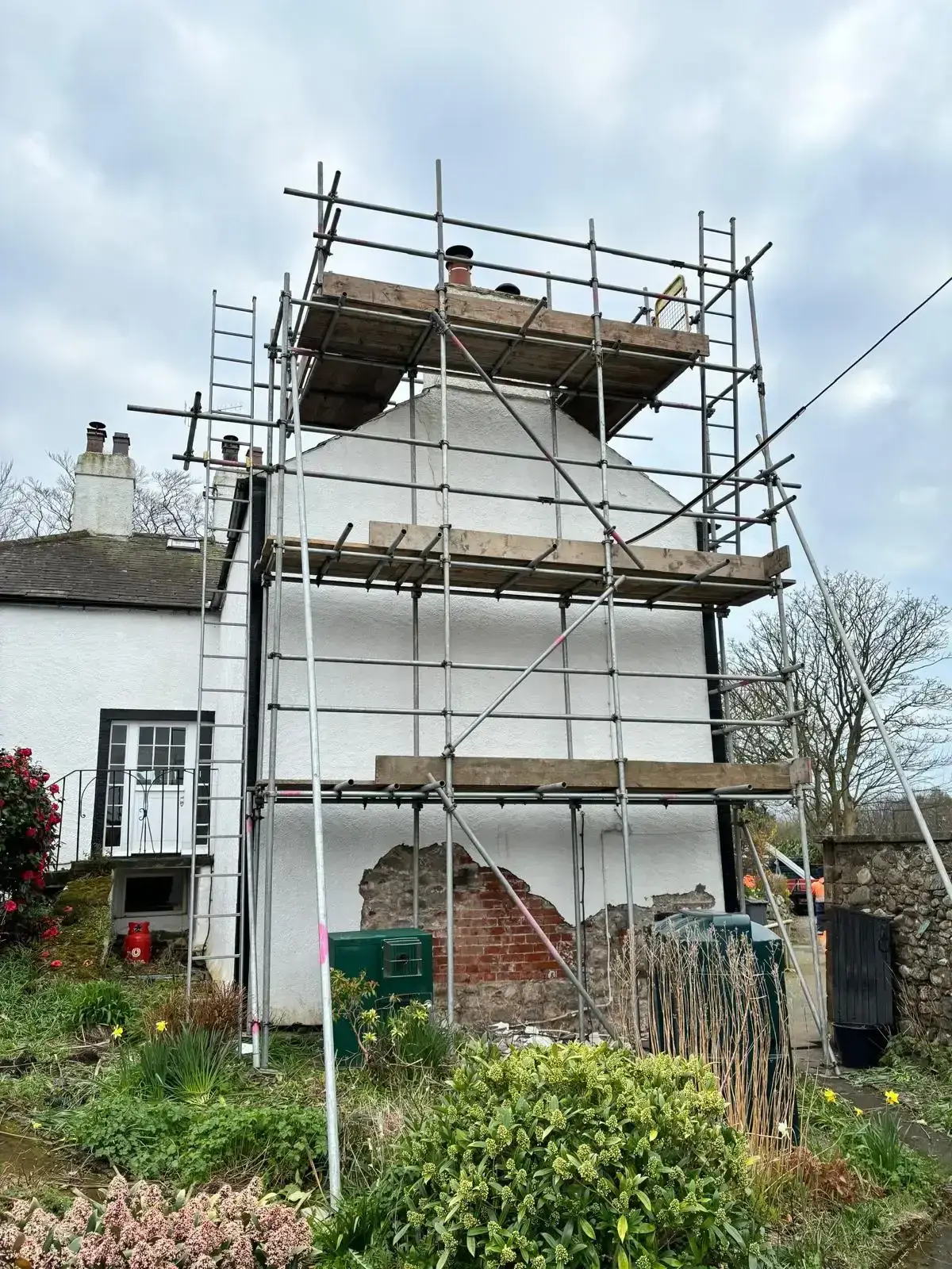Chimney scaffolding on slate roof providing access for repointing work