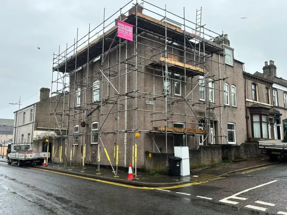 House wrap scaffold on end-terrace property for gable end work in Cumbria