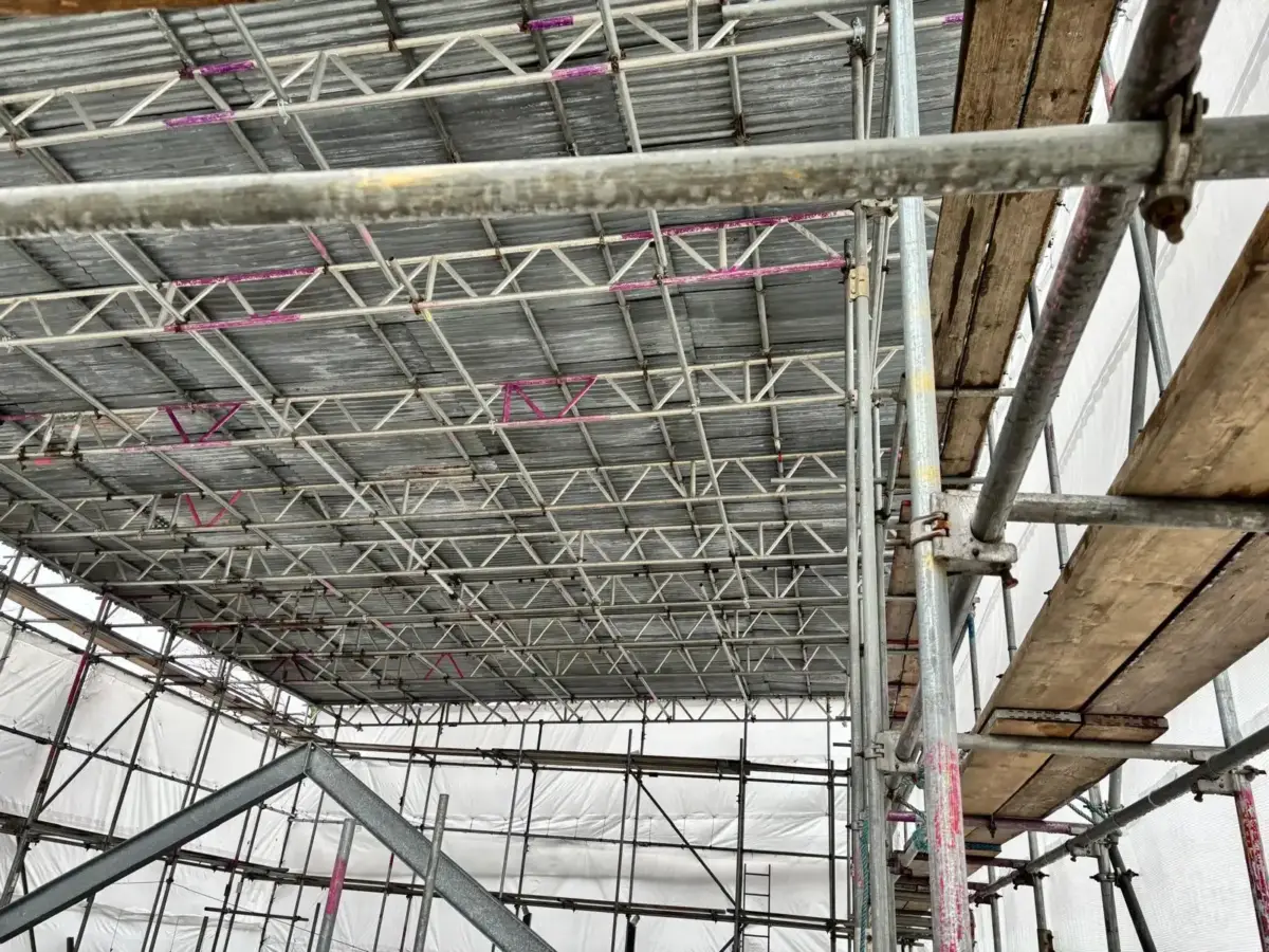 Completed temporary roofing scaffold with protective sheeting in place